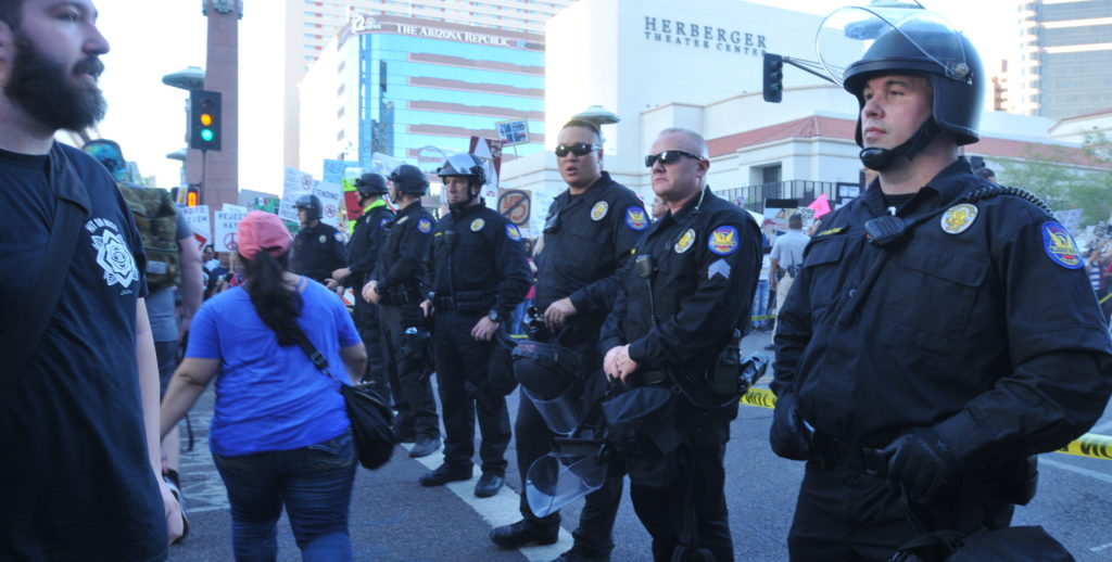 Manifestantes protestan a las puertas del Centro de Convenciones de Phoenix donde Donald Trump ofrece un mitin